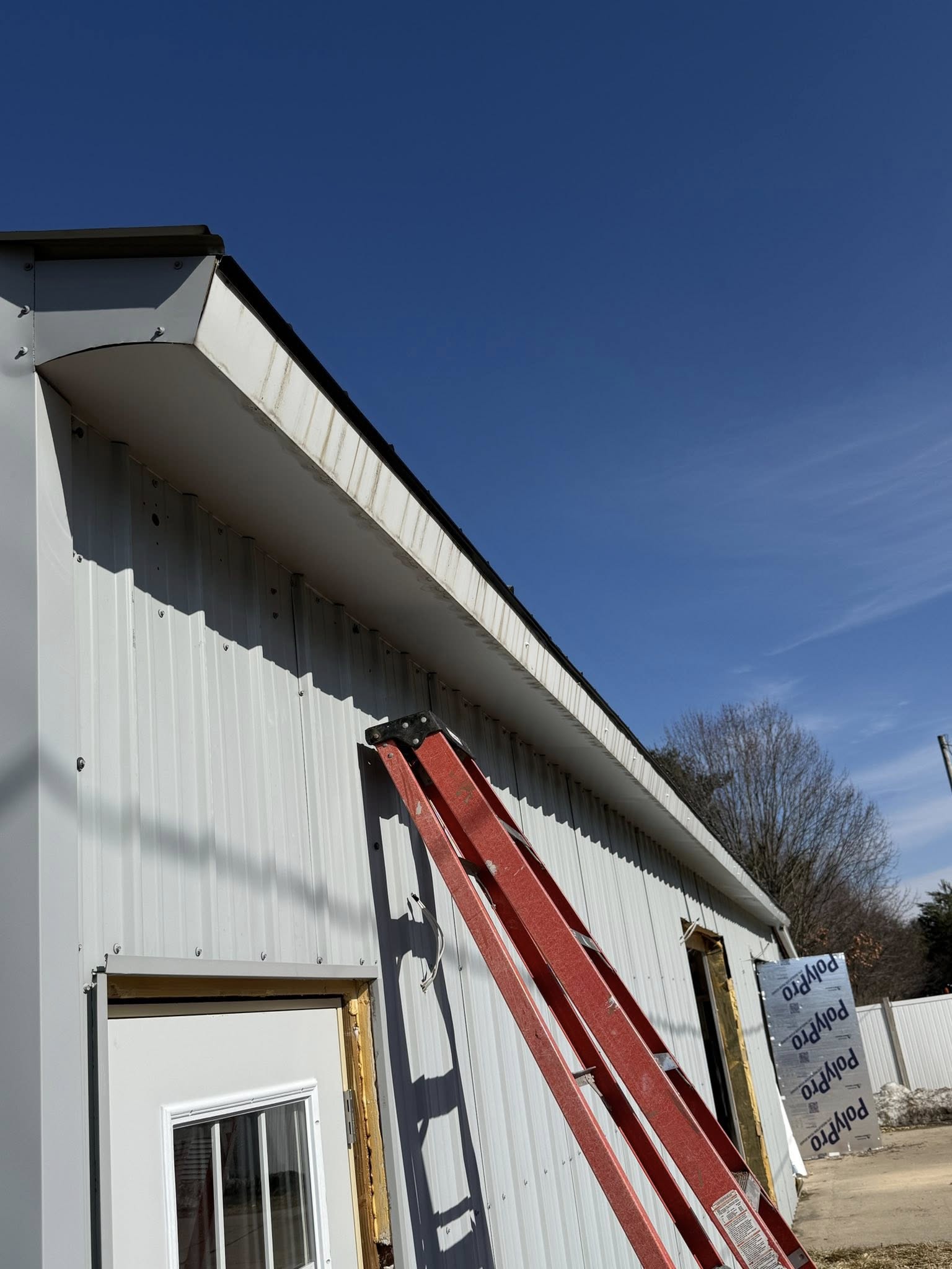 Roofline and gutter guard installation on modern home
